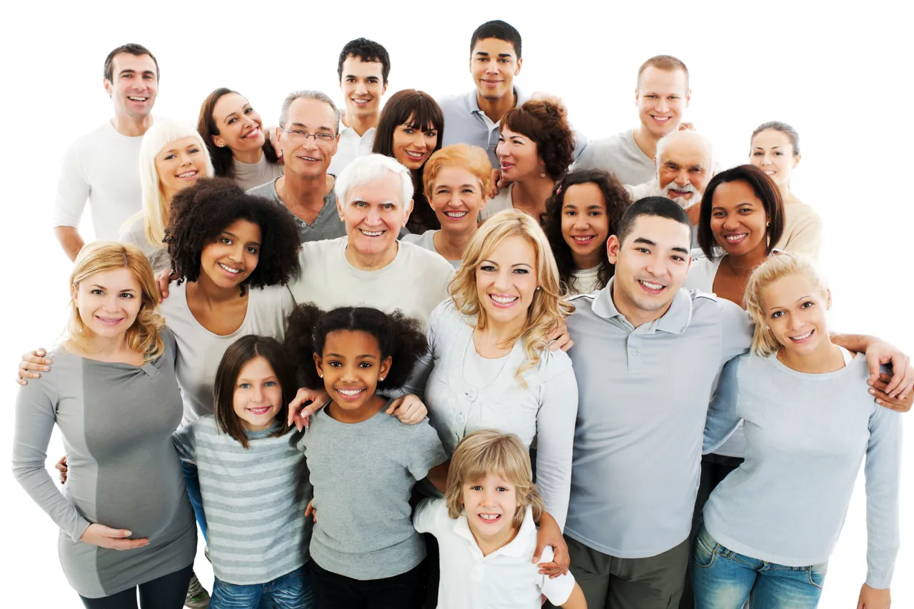A diverse group of people of various ages are smiling, standing close together as if they've just left a counseling session in Sugar Land, TX. They are all wearing light-colored clothing against a plain white background, radiating positivity and unity.
